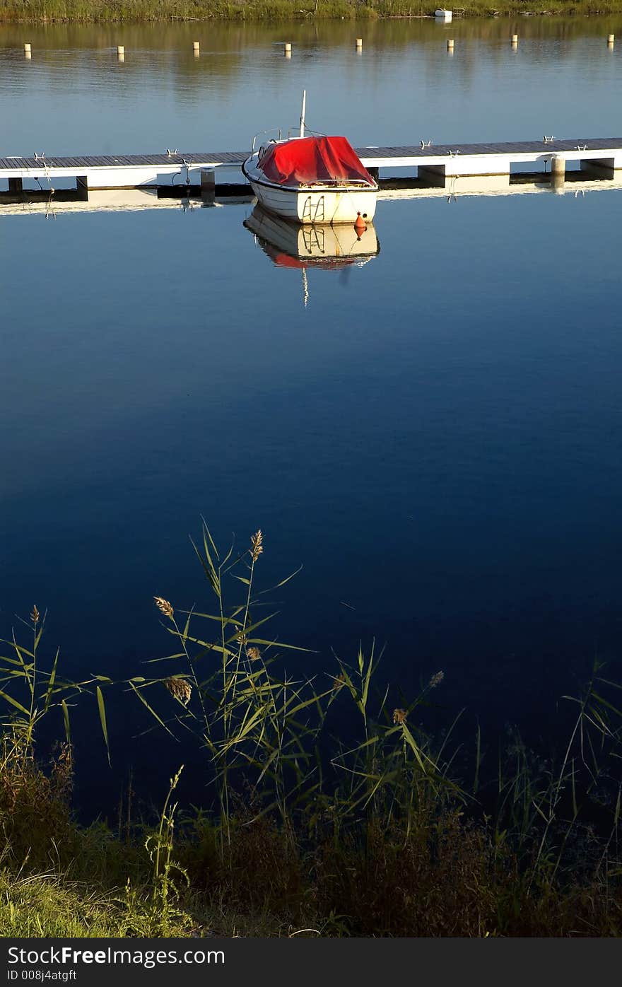 Lake mole with clear blue ad peacefully water and boat