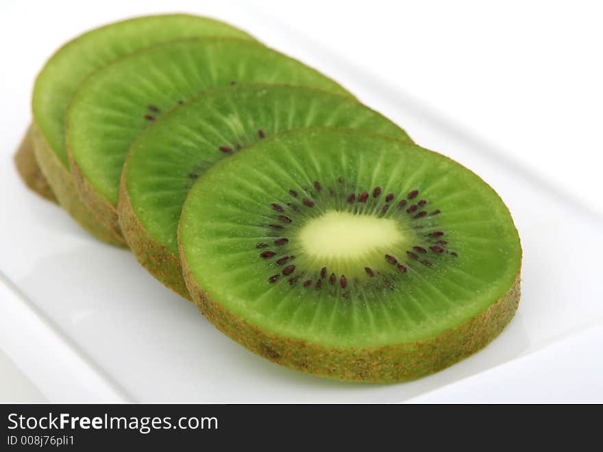 Fresh tropical green kiwi fruit, macro closeup, isolated on white, close-up with copyspace. Fresh tropical green kiwi fruit, macro closeup, isolated on white, close-up with copyspace