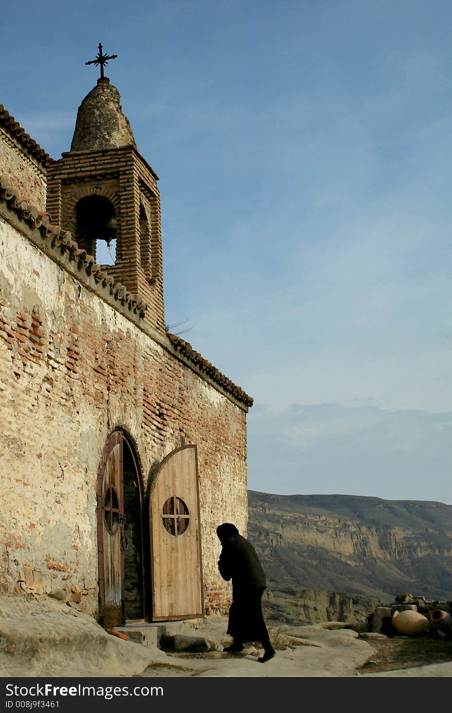 Old woman entering church