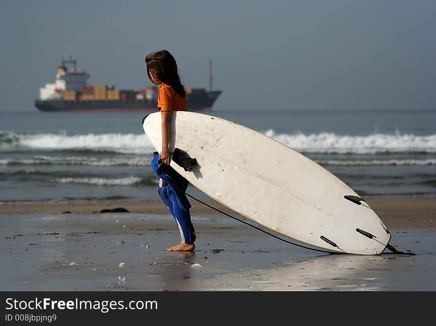 Little surfer in the beach