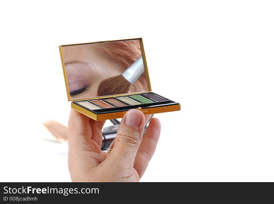 Reflection of a beautiful women applying makeup