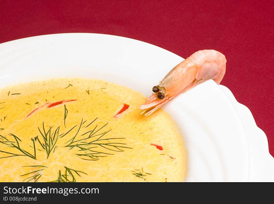 Think shrimp soup with shrimp decorations over royal red background. Think shrimp soup with shrimp decorations over royal red background