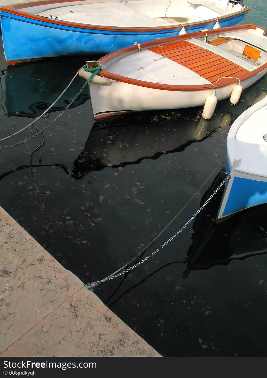 A closeup of three boats on the Lake Garda (Italy)