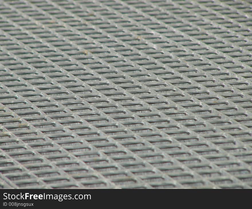 Photo of metal grid in factory used as cover of canal