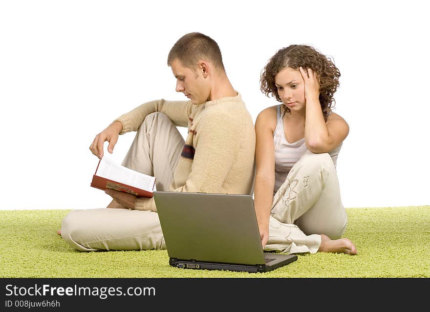 Isolated on white young couple on green carpet with laptop and book