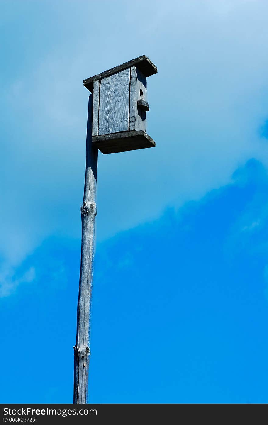 Nestling box in the blue summer sky. Nestling box in the blue summer sky