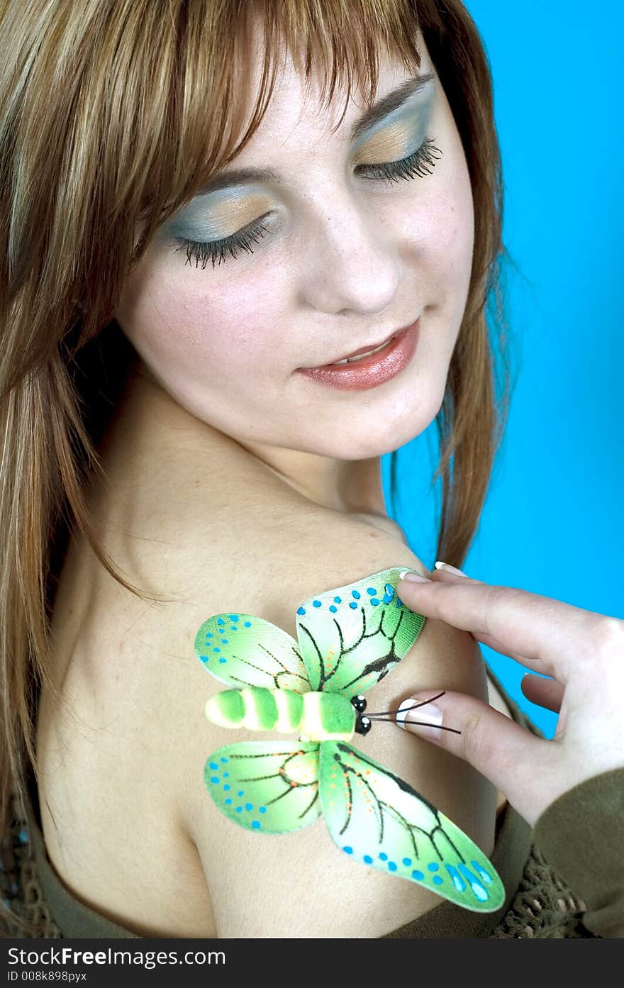 young woman on a blue background, with a sensual, luring expression and a kinky fish-net top. young woman on a blue background, with a sensual, luring expression and a kinky fish-net top