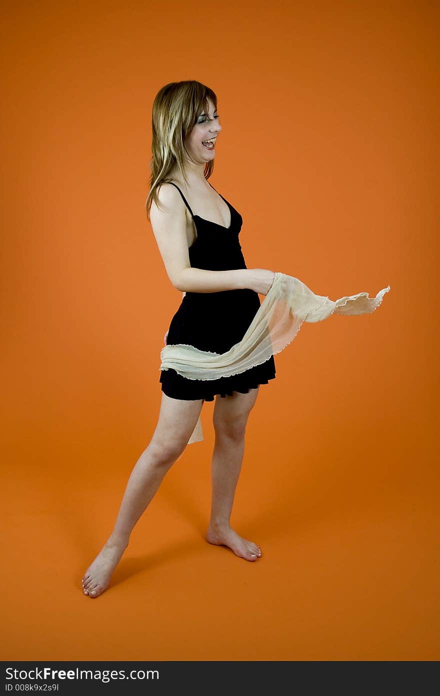 Sexy young woman on a dark orange background, dances and laughs. Sexy young woman on a dark orange background, dances and laughs