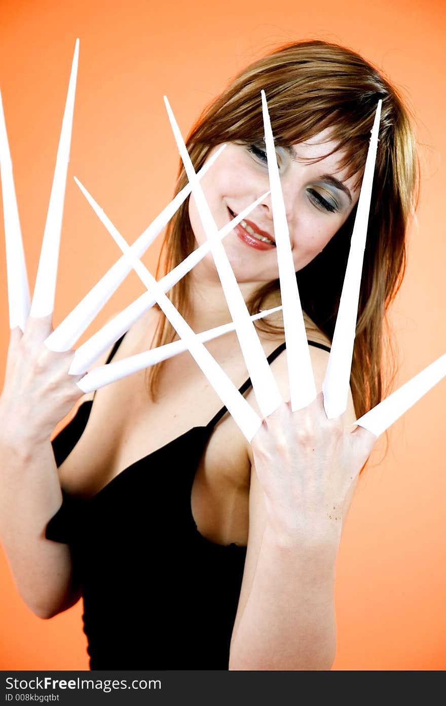 Funny looking cute girl poses with scissor fingers made out of paper - Freddy Kruger style