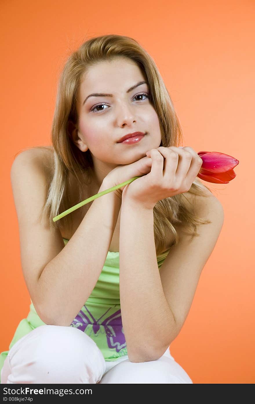 Blond girl and red tulip