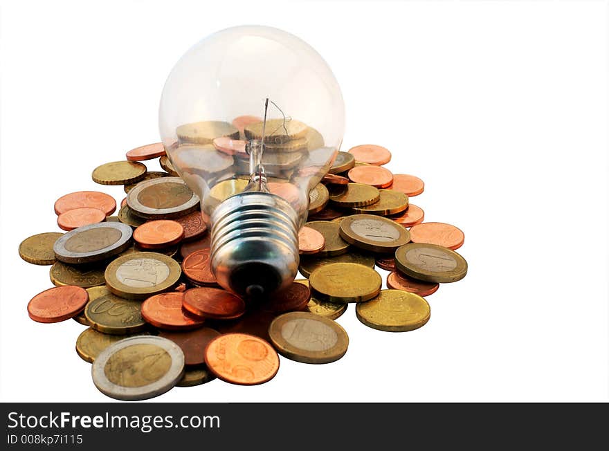 A lightbulb on some coins. A lightbulb on some coins