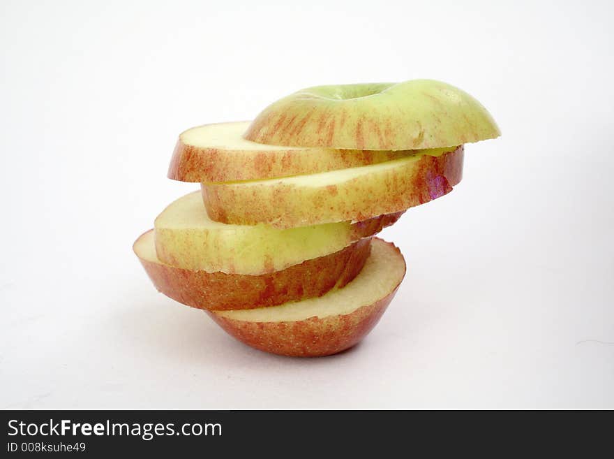 Six apple slices on-top of each other. Six apple slices on-top of each other.