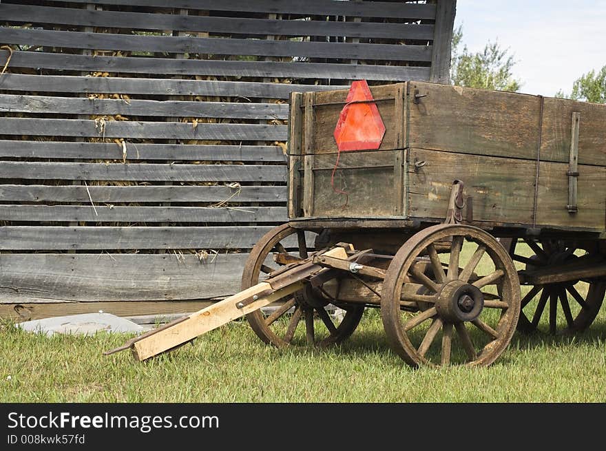 Weathered corn crib and old farm wagon. Weathered corn crib and old farm wagon