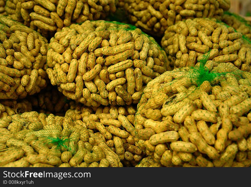 Peanuts on display in green nets