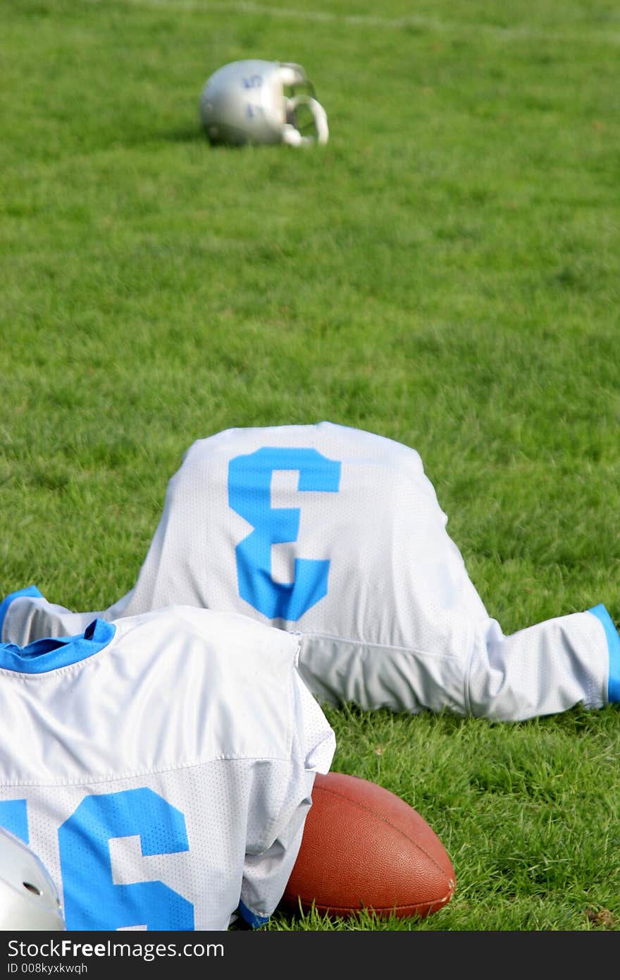 Jersey, ball and helmet on the grass. Jersey, ball and helmet on the grass