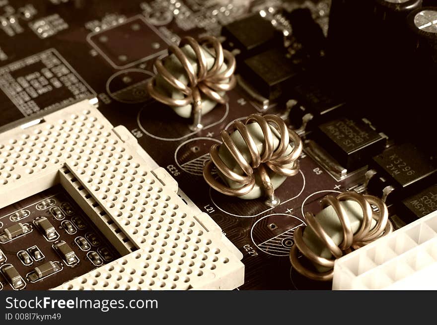 Motherboard - processor socket and coils, sepia.