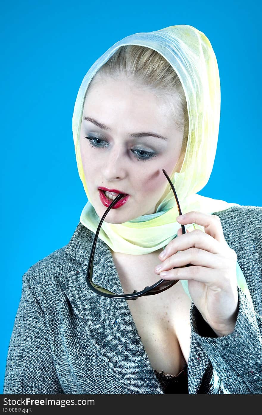 Portrait of a beautiful young blond with casual clothes posing in a studio; nice looks and make-up; expression of the 60's isolated on orange. Portrait of a beautiful young blond with casual clothes posing in a studio; nice looks and make-up; expression of the 60's isolated on orange