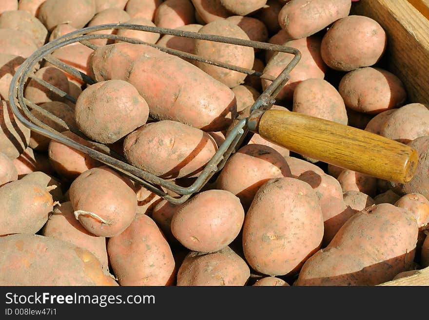 Potatoes tray and a rack on a marketplace.