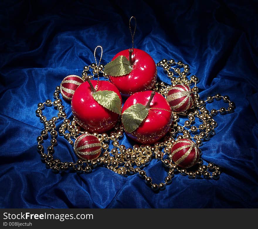 Various Christmas ornaments on a blue fabric