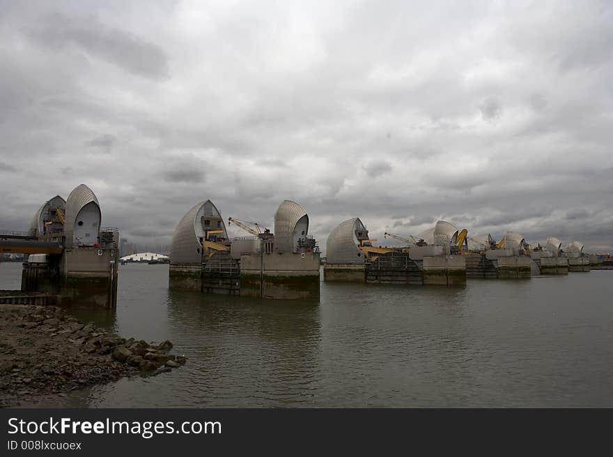 Thames barrier the millennium dome can be seen in the gap between two of the gates woolwich docklands london city england taken in september 2006