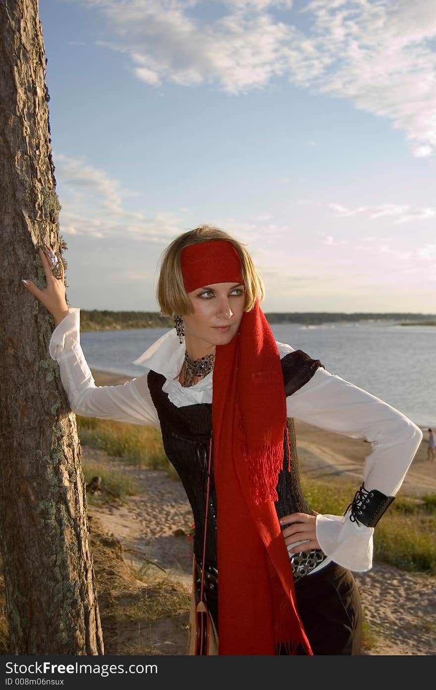 Pirate girl waiting for her ship on a beach