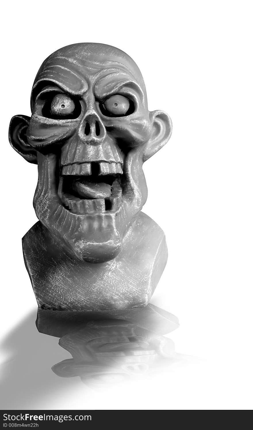 Ghoulish gargoyle face perfect for Halloween, with reflection. Ghoulish gargoyle face perfect for Halloween, with reflection