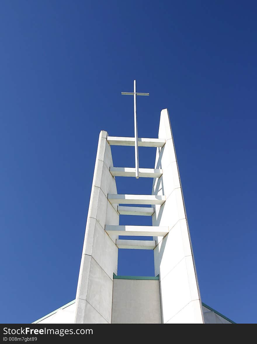 White cross stands against a blue sky