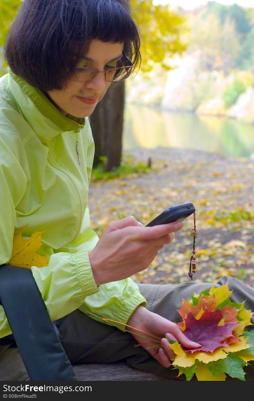 The woman with leaves and a mobile phone