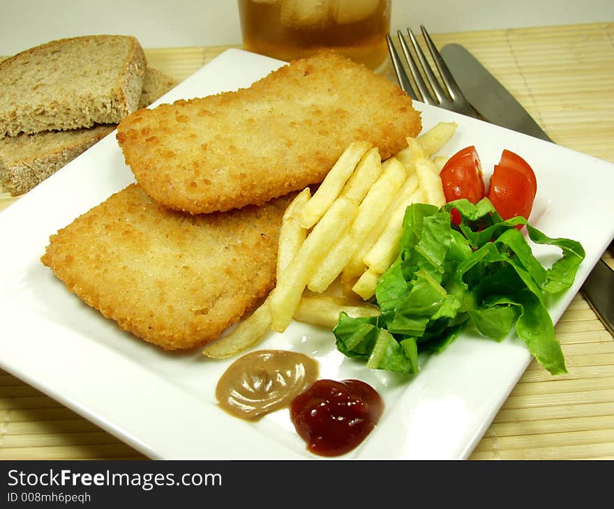 Fried traditional cordon bleu whit french and salad