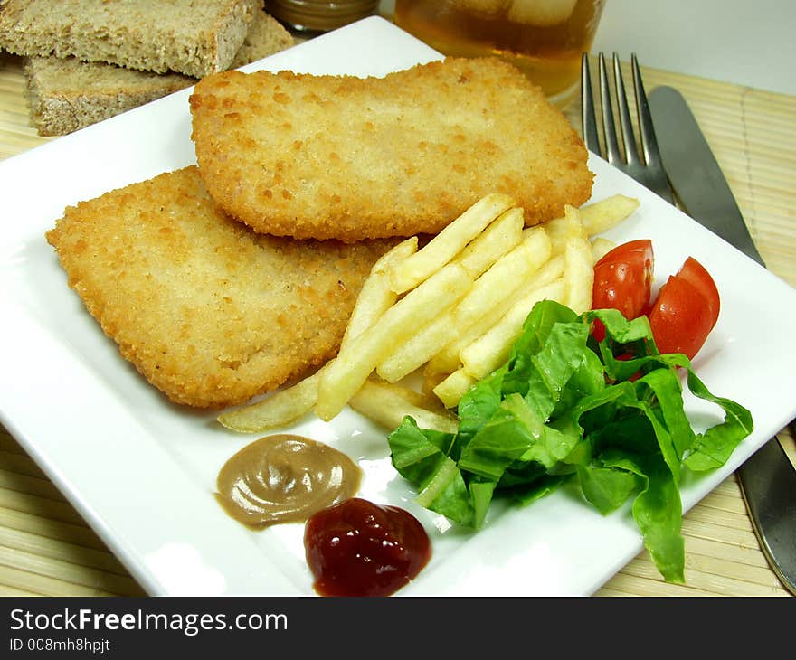 Traditional cordon bleu whit fried, salad, mustard and ketchup