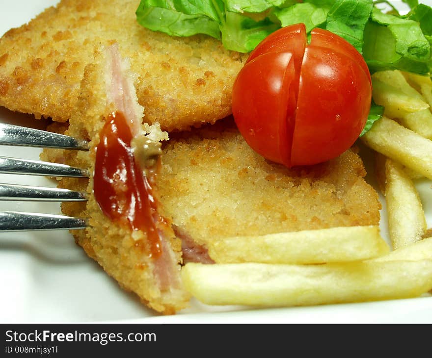 Close up of piece of cordon bleu whit fresh tomatoe