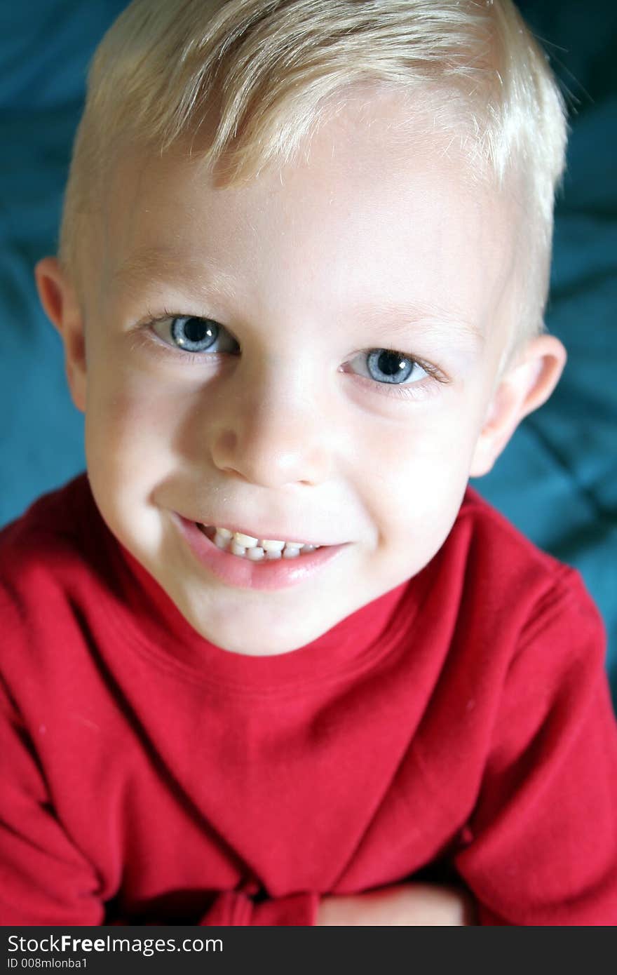 This boy has blue eyes and blond hair as he makes a silly face. This boy has blue eyes and blond hair as he makes a silly face.