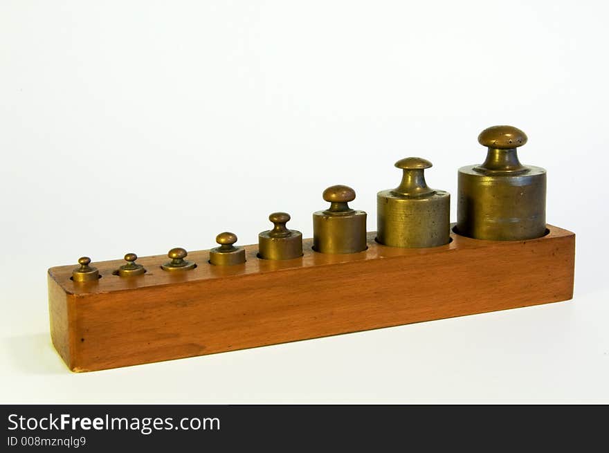 A set of lead weights in a shaped wooden box