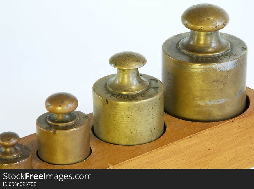 A set of lead weights in a shaped wooden box