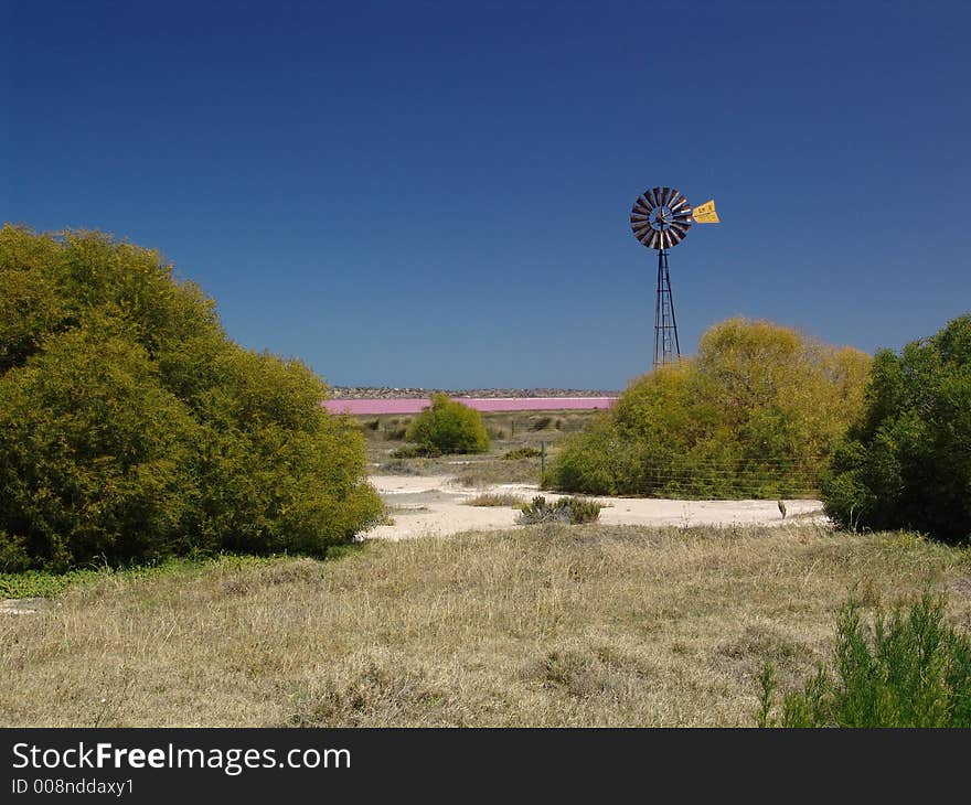 Wind-wheel before a pink-colored lagoon. Wind-wheel before a pink-colored lagoon