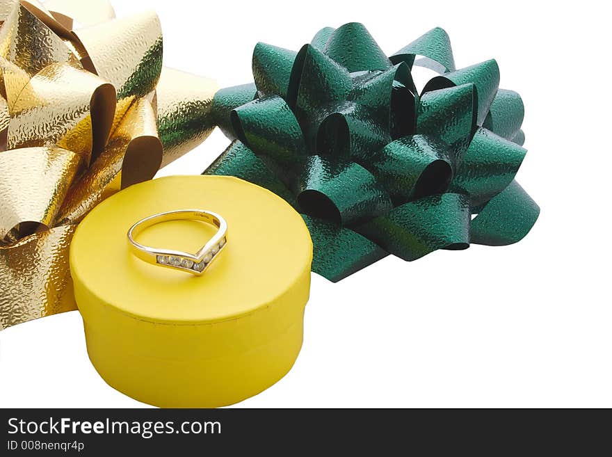 A ring on top of its gift box and ribbons isolated. A ring on top of its gift box and ribbons isolated