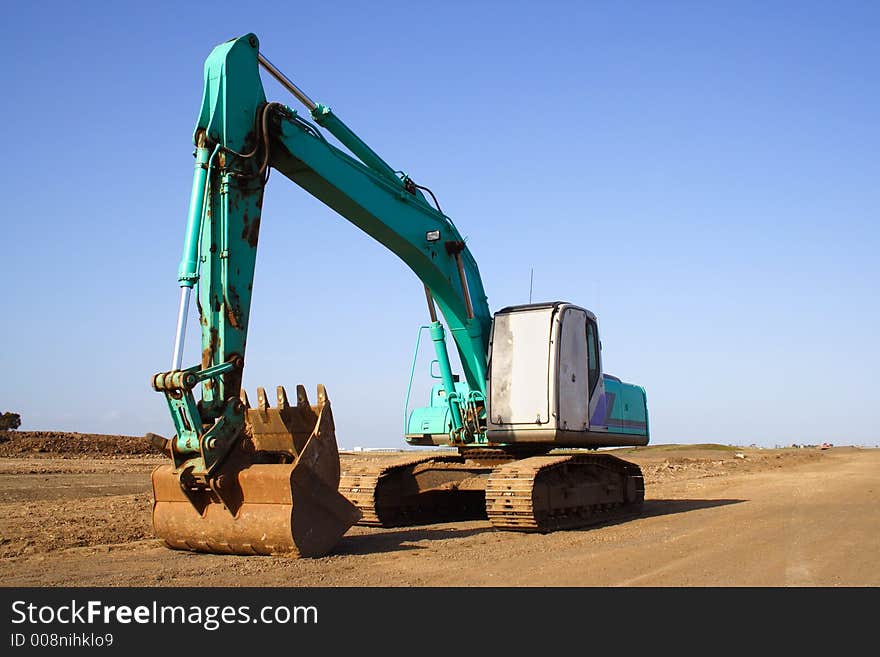 Earth mover excavator clear blue sky