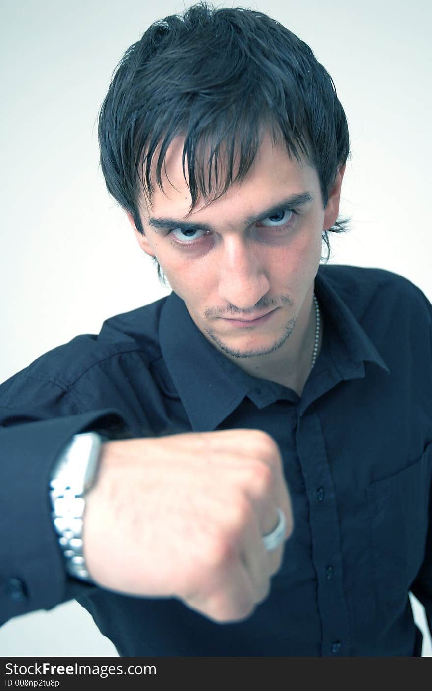 Portrait of a young boy wearing a black shirt posing in a studio; isolated on orange. Portrait of a young boy wearing a black shirt posing in a studio; isolated on orange