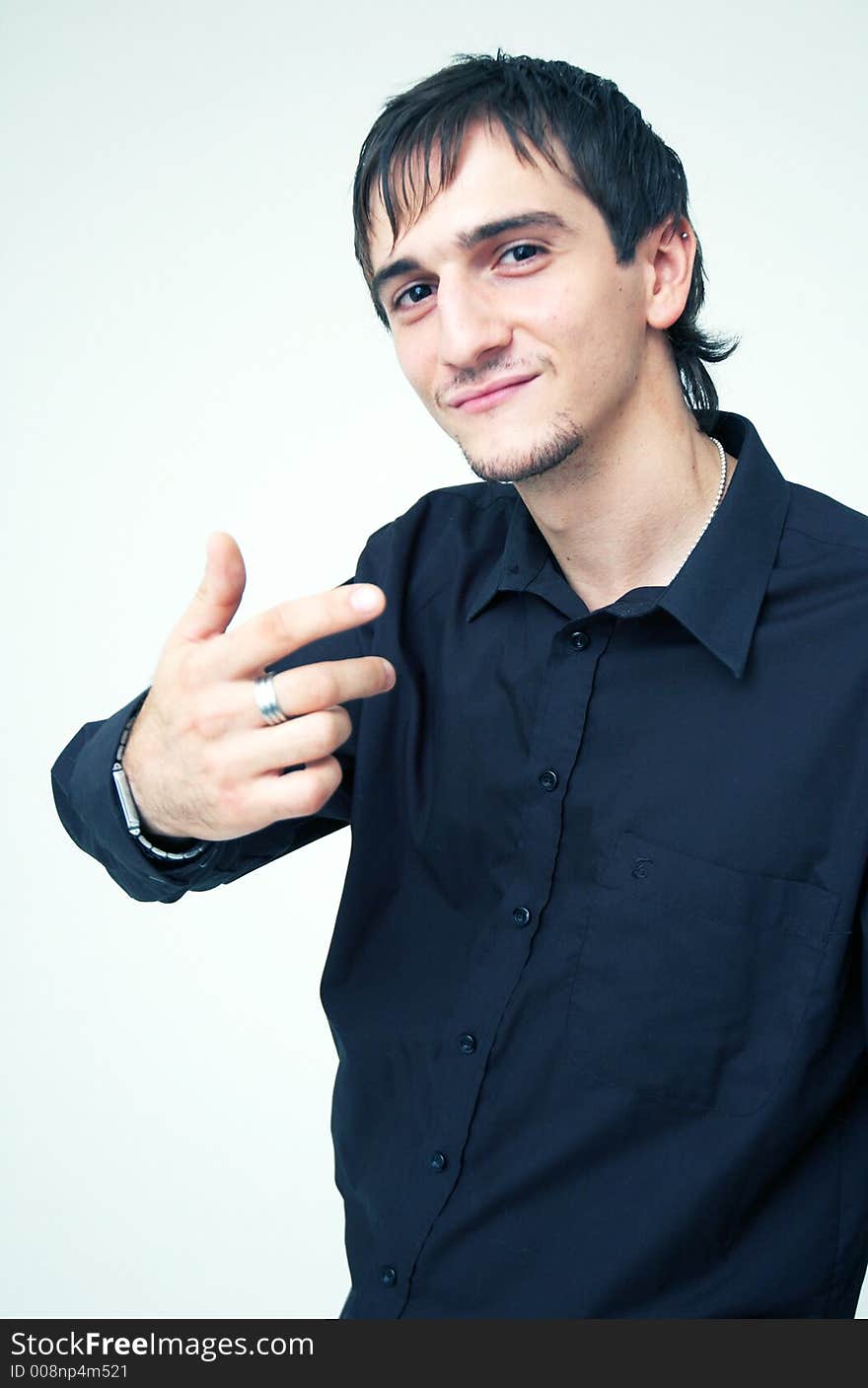 Young boy with black shirt and ring on his finger having a cool expression. Young boy with black shirt and ring on his finger having a cool expression