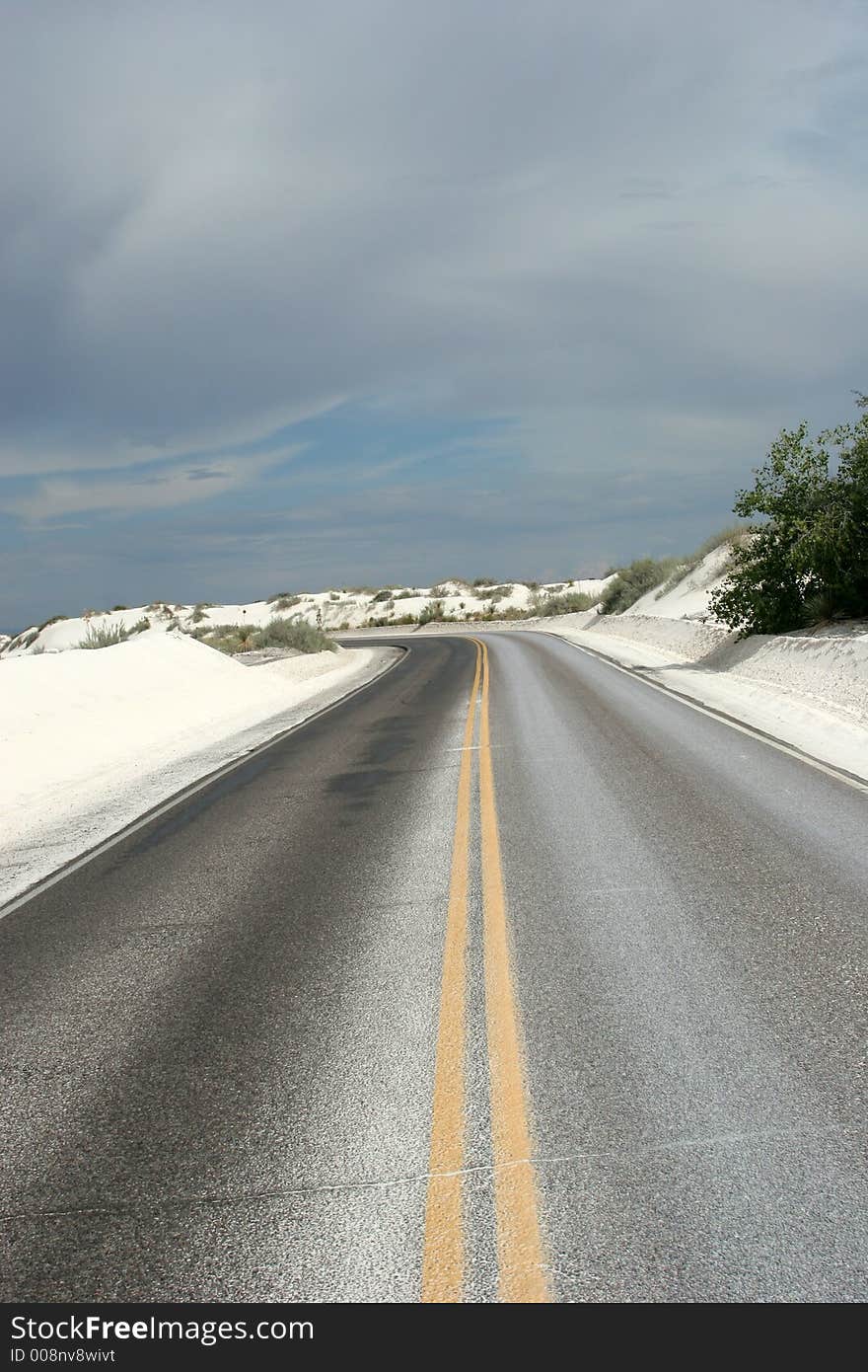 Desert highway in white sand dunes