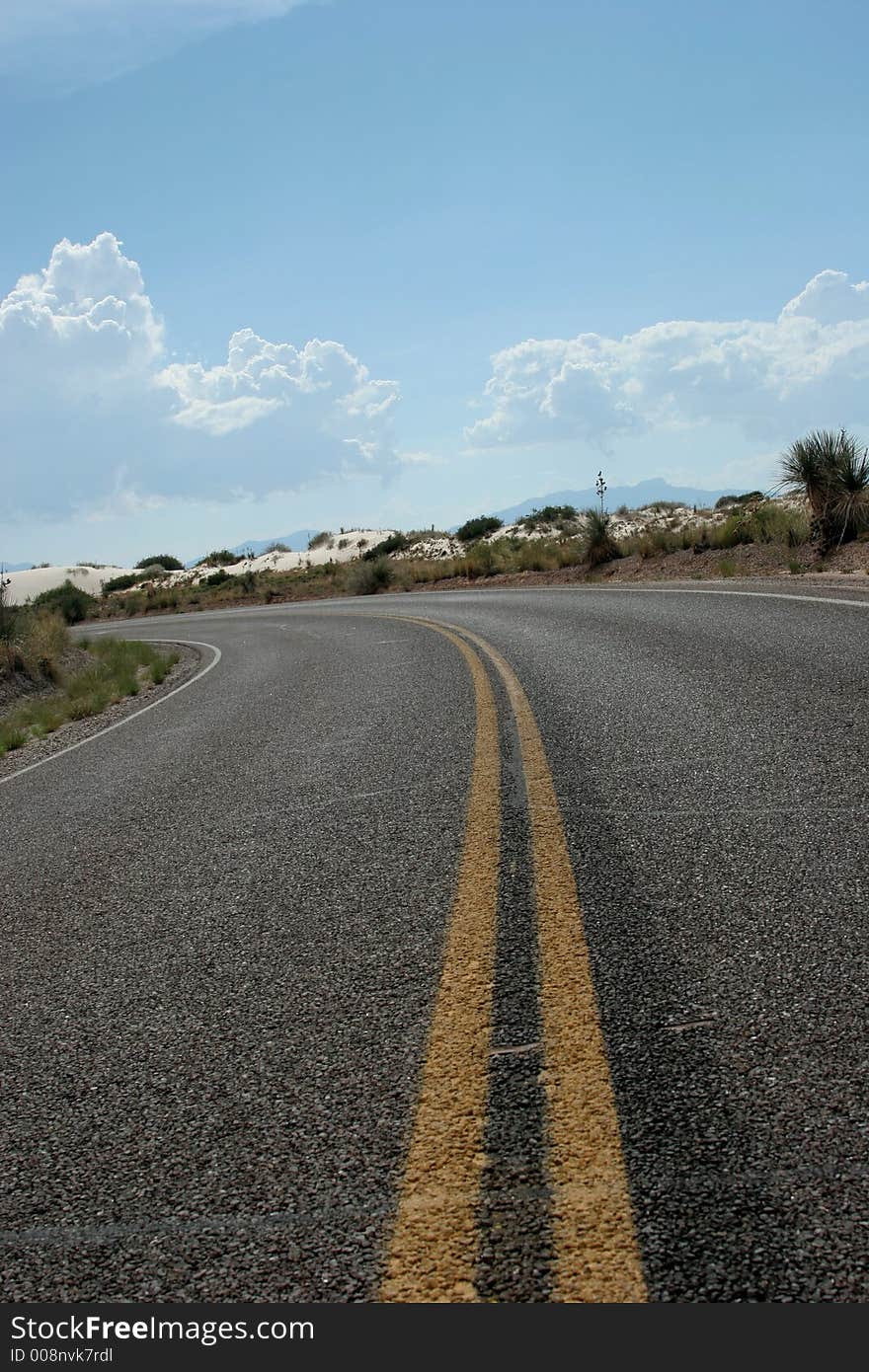 Desert highway in white sand dunes