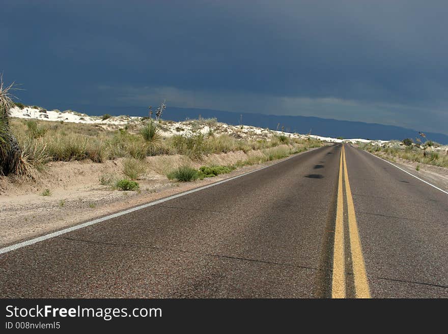 Desert highway in white sand dunes