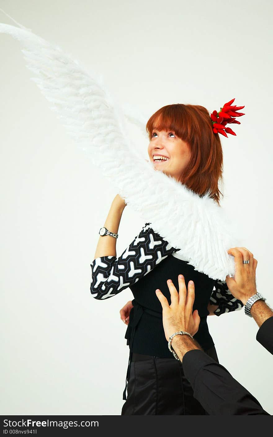 Man hands reaching a beautiful redhead girl with angel wings. Man hands reaching a beautiful redhead girl with angel wings