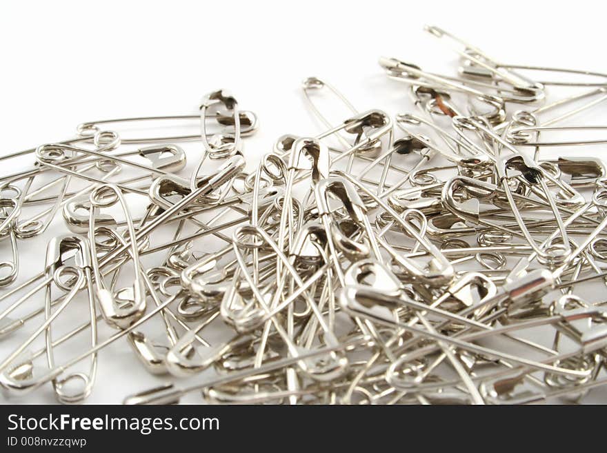 Safety pins on a white background