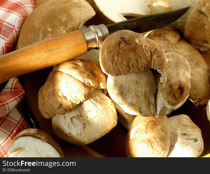 Mushrooms in a plate with a knife and a towel