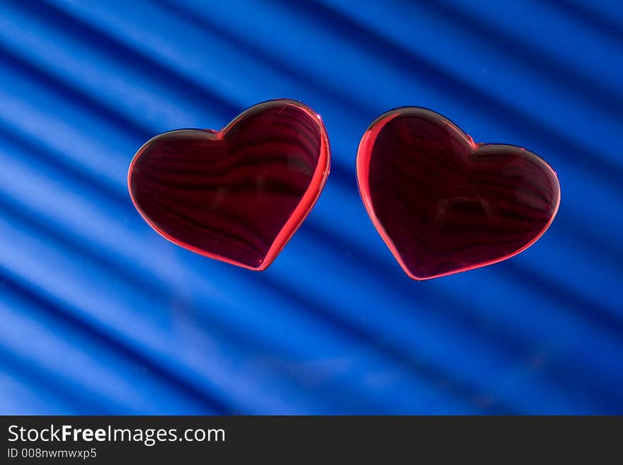 Two heart. Tho glass heart on blue background.