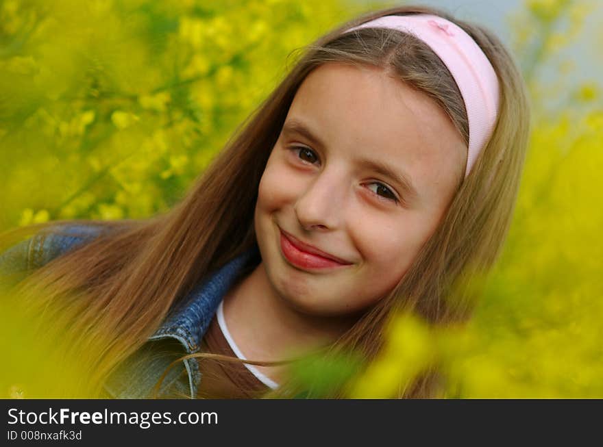 Portrait of young girl in yellow flowers