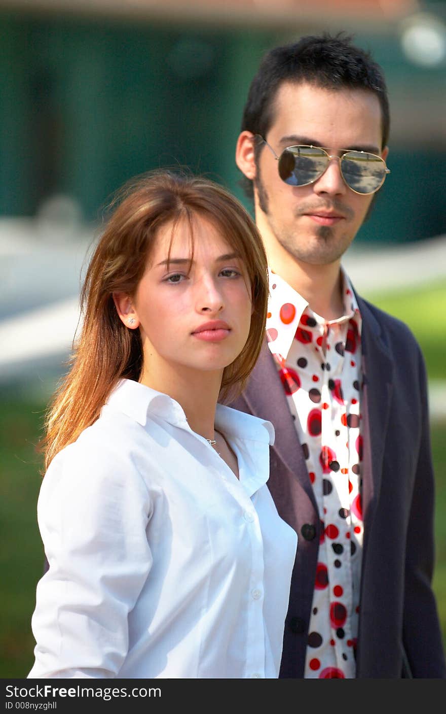 Portrait of a young business couple in a park, looking confident in their youth and abilities. Portrait of a young business couple in a park, looking confident in their youth and abilities