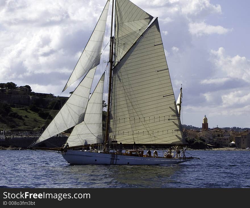 Classic sailing yacht Veronique Gliding in a light breeze at the village of St-Tropez