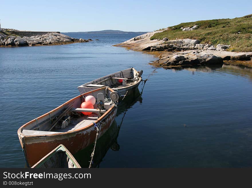 Three small boats in the water in Peggy´s Cove. Three small boats in the water in Peggy´s Cove